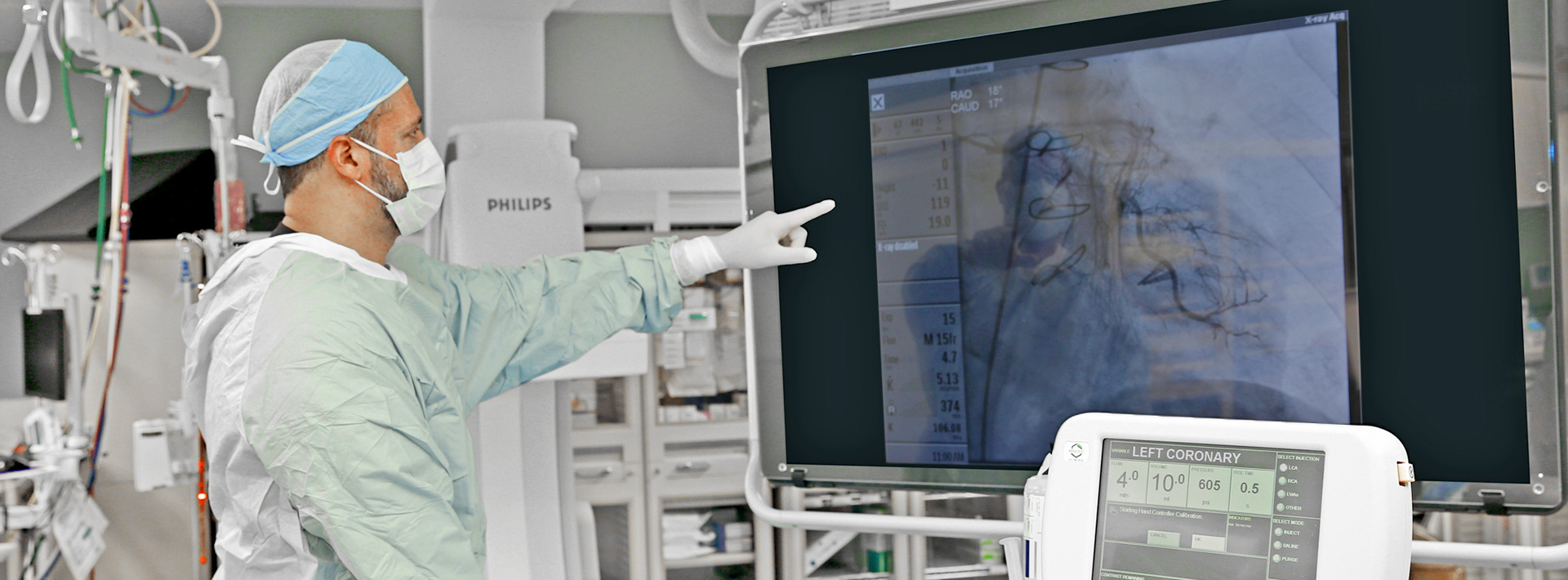 Doctor pointing to screen in operating room